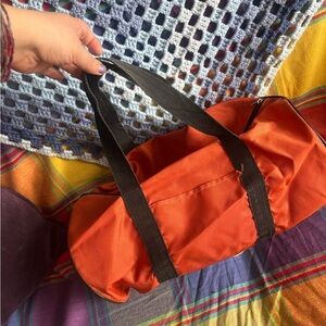 Bright Orange Duffel Bag with Black Handles​